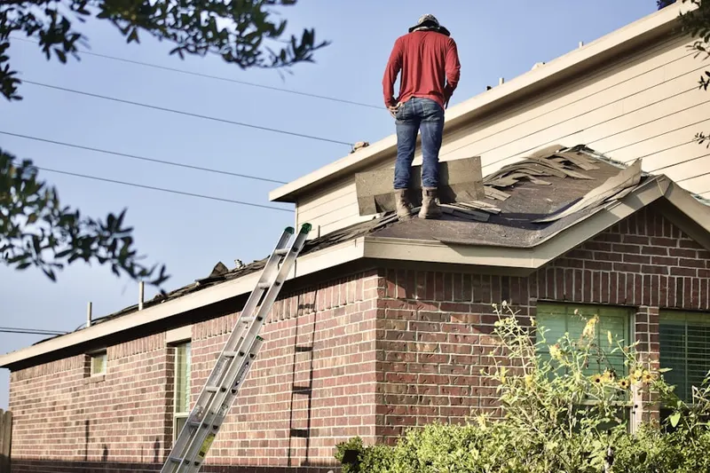 Professional roofer working on a residential roof in Downtown Asheville